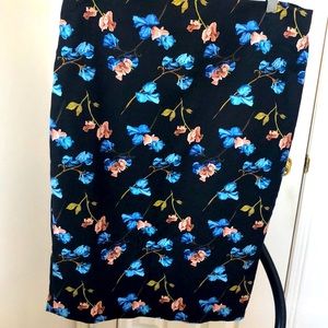 Black pencil cotton skirt with the bright flowers pattern